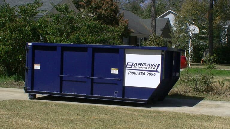 dumpster delivered in a driveway