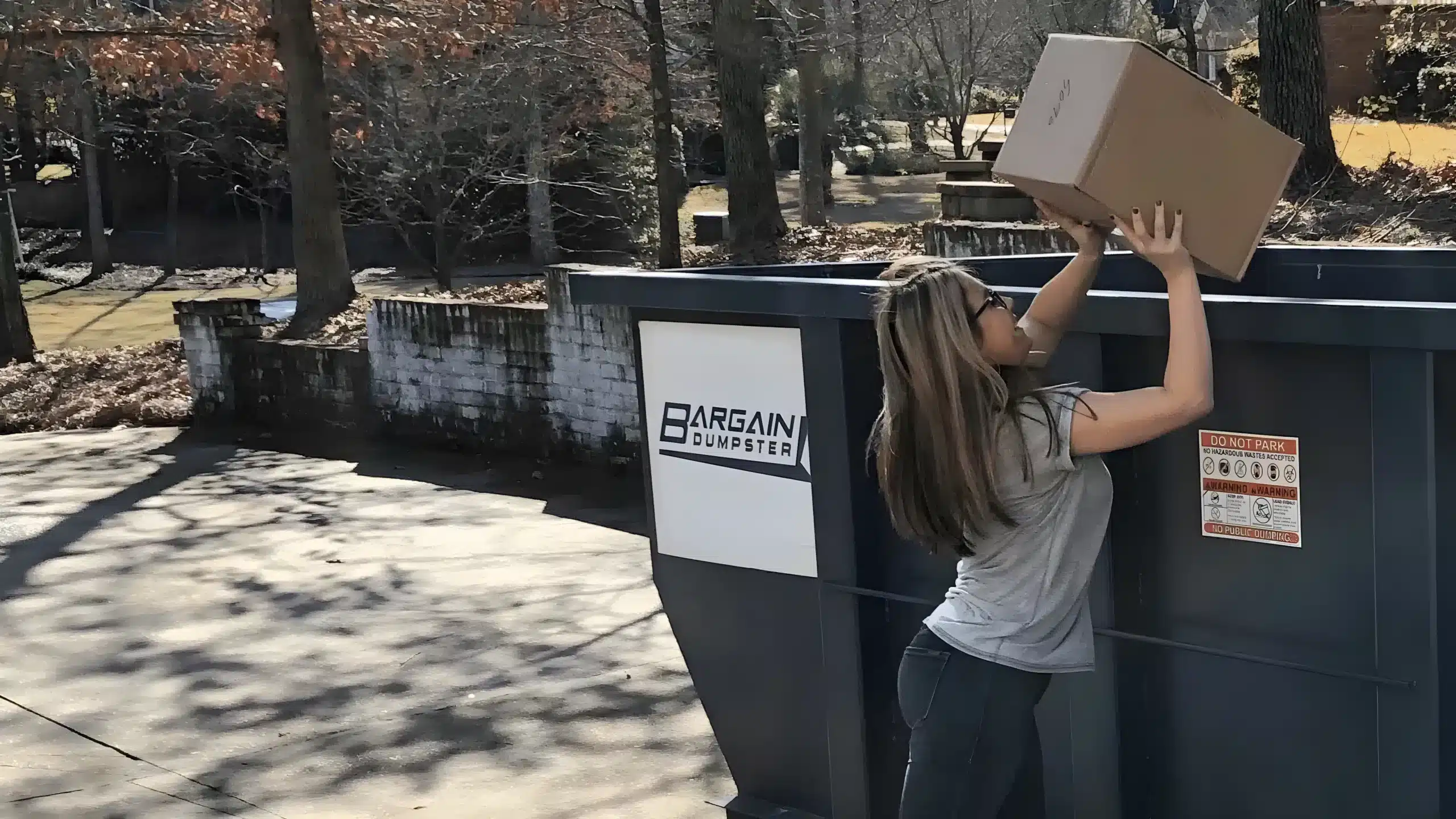 Woman Loading a Bargain Dumpster Container