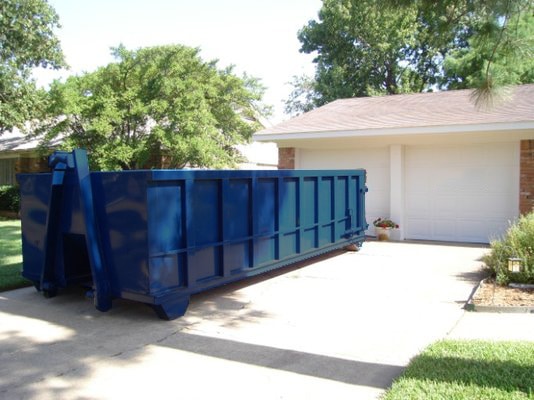 Roll-off dumpster in a driveway during a home renovation project in Charlotte, NC.