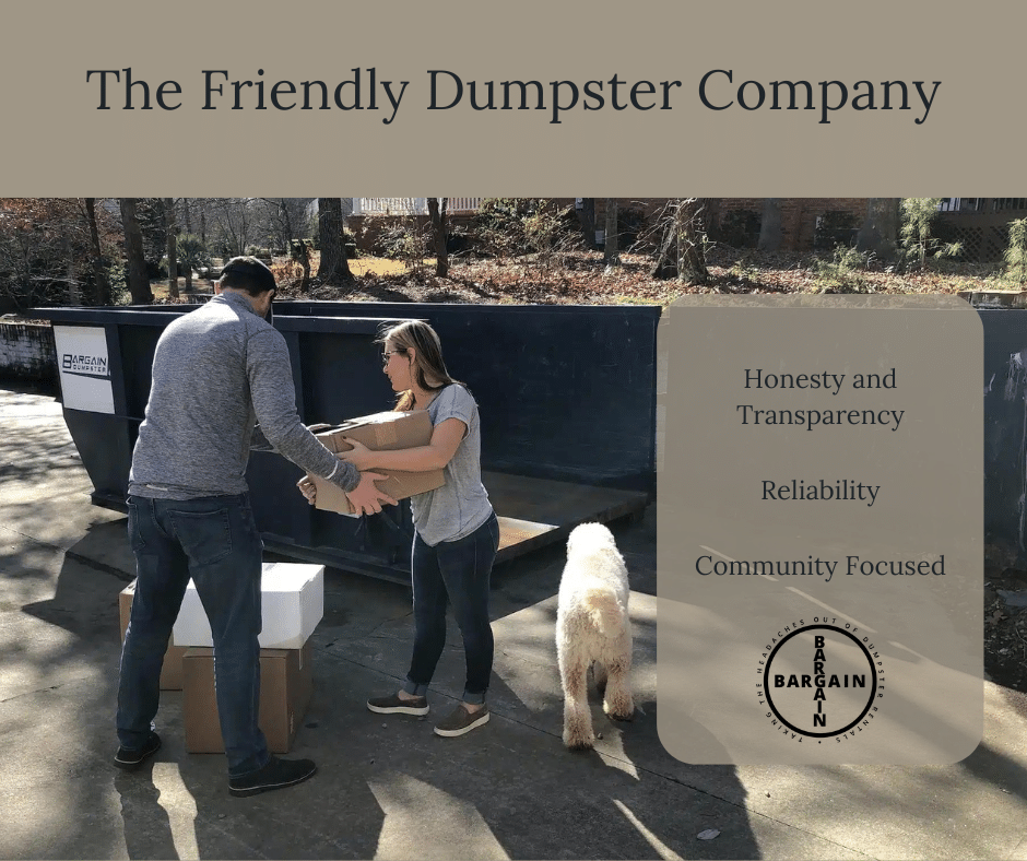 Image of a happy couple and their dog loading a Bargain Dumpster roll-off container with boxes