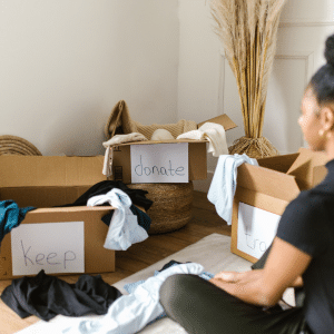 Image of a woman decluttering a room using the keep, donate, trash model