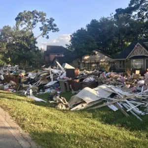 A residential neighborhood after a major storm with piles of debris