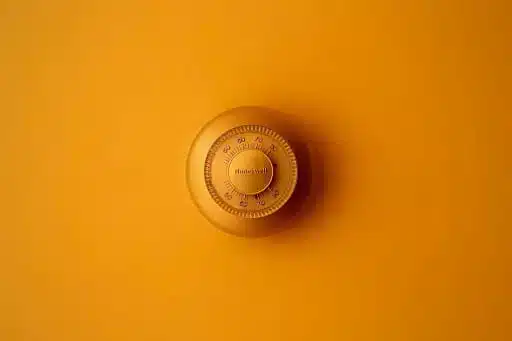 a yellow thermosta on a yellow wall