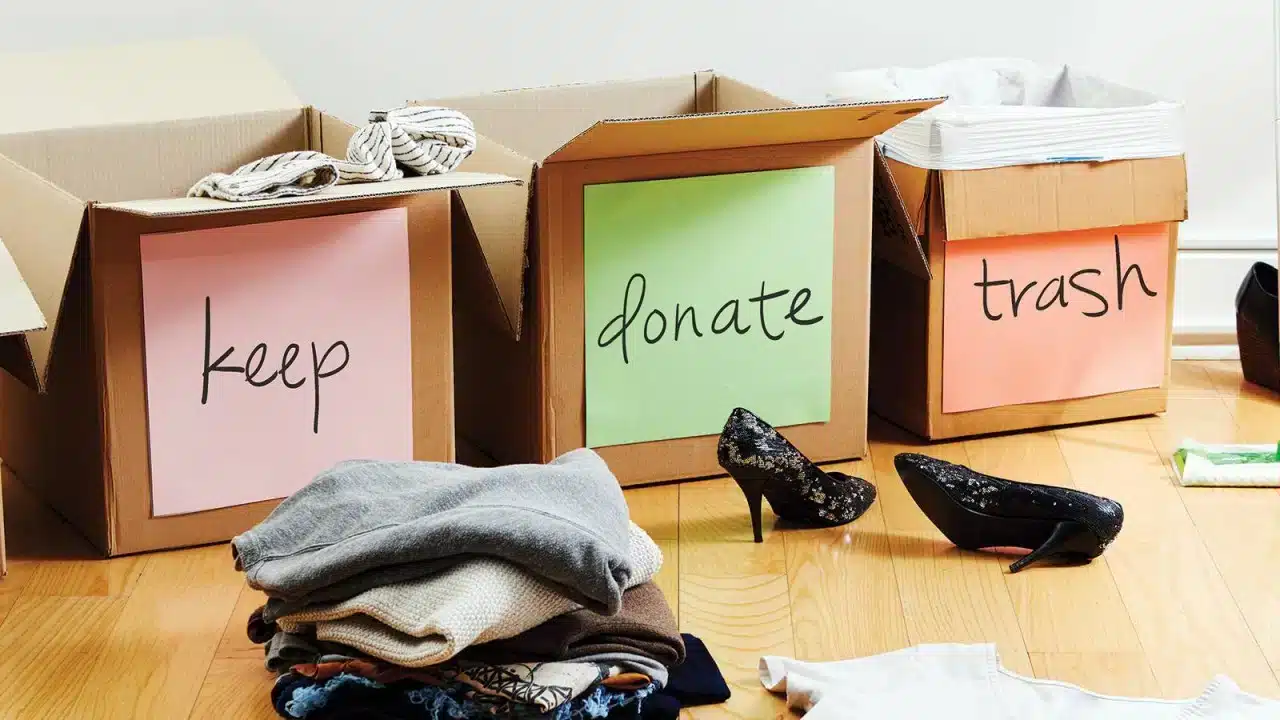 3 boxes, one labeled keep, one donate, and the 3rd trash