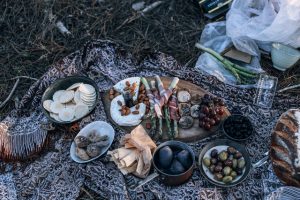 picnic in the woods with food and wine