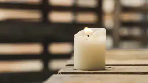 a candle sitting on a wooden table
