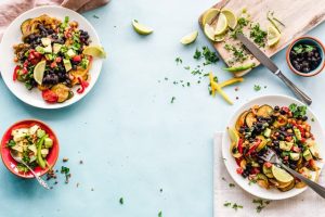 a plate of food with black beans, avocado, and salsa