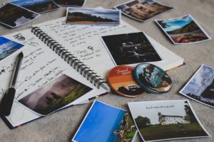 a notebook with photos and a pen on it