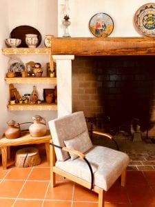 a chair and a fireplace in a room with a fireplace