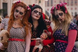three girls dressed up in halloween costumes