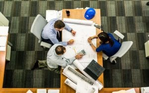 a group of people working at a desk