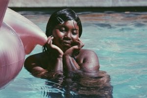 a woman in a pink flamingo float