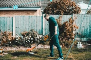 a man is using a lawn mower in his backyard
