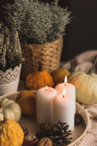 a table with candles and pumpkins on it