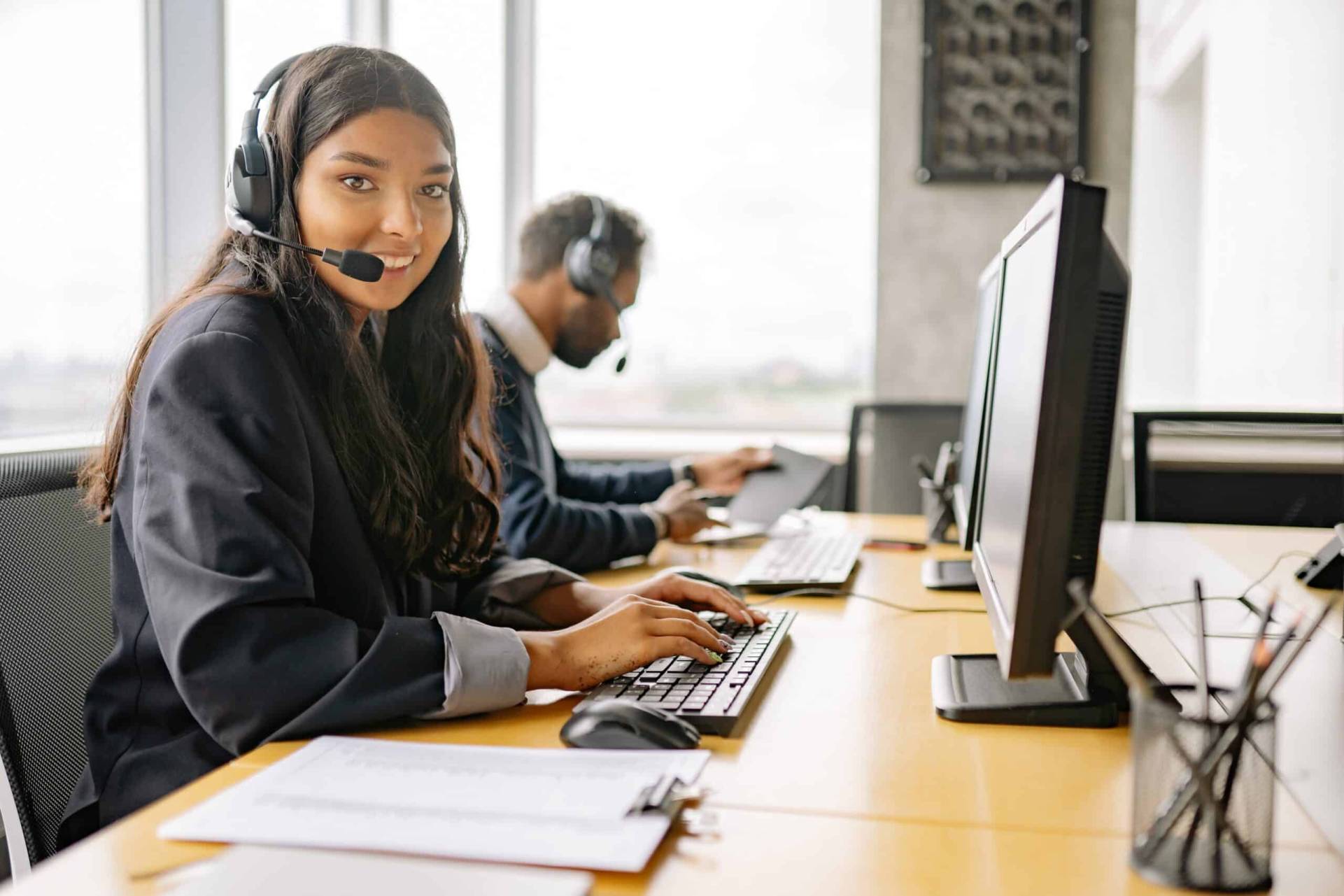 Bargain Dumpster account representative on the phone smiling